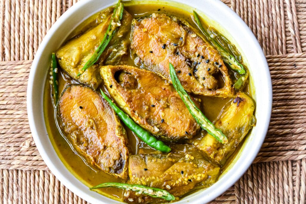 Delightful Bengali Cuisine: A Plate of Ilish Machher Jhol, a Traditional Hilsa Fish Curry