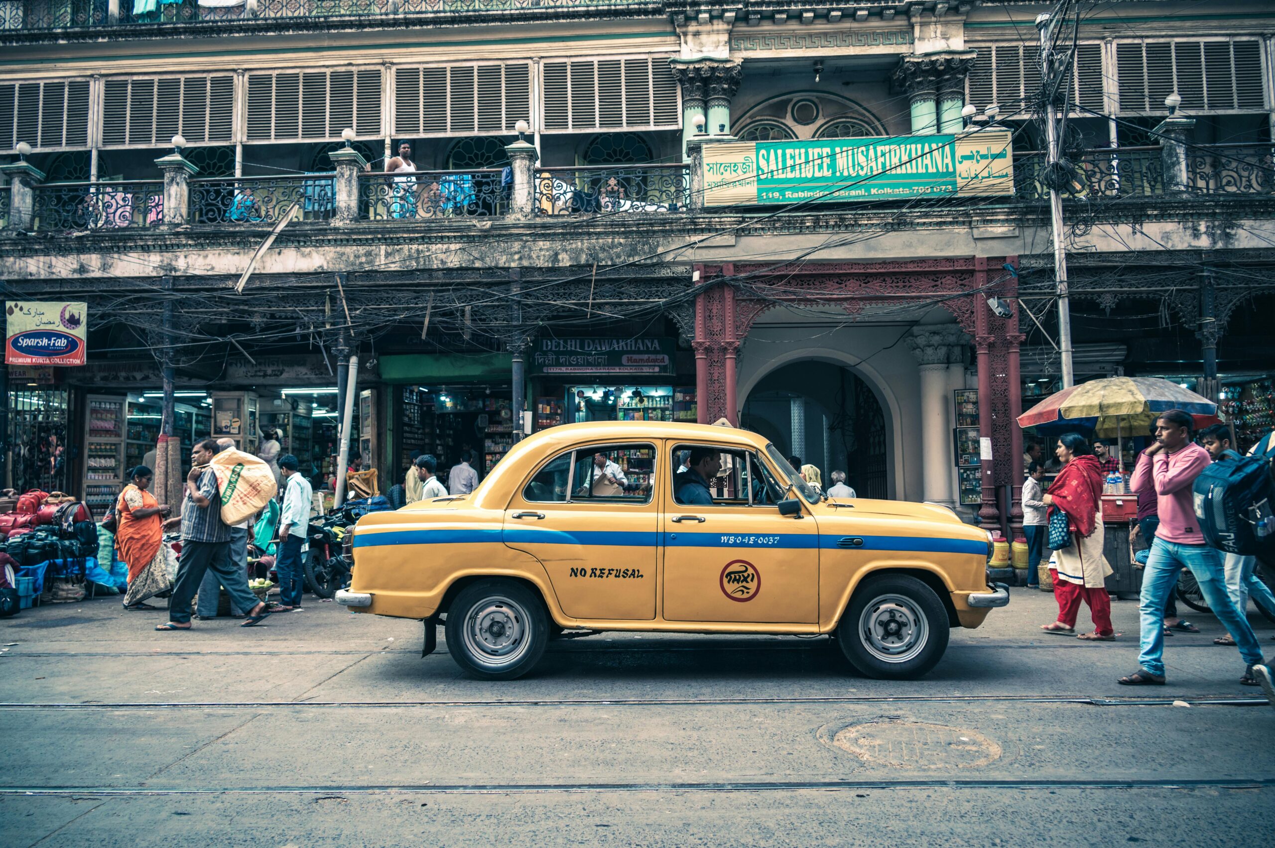 A vibrant cityscape with colorful buildings and bustling streets, capturing the lively atmosphere of the 'City of Joy