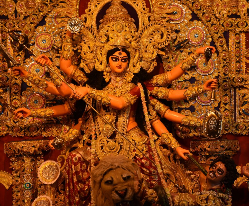 A vibrant image showcasing the grandeur of Durga Puja celebrations, with intricately crafted idols, colorful decorations, and joyful devotees immersed in the festivities.